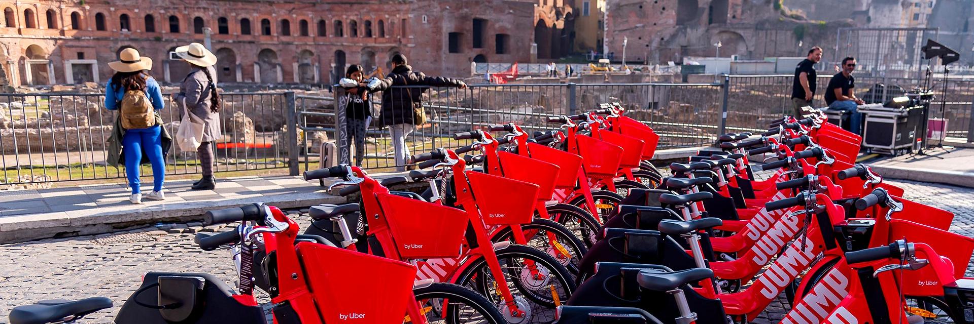 A row of affordable red electric bikes in Rome, Italy.