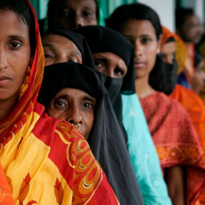 Bangladeshi villagers line up to have their photographs and signatures taken as part of a United Nations Development Programme (UNDP) voting initiative.