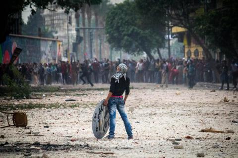 A protester holding a makeshift shield stands on Mohammed Mahmoud Street in downtown Cairo.