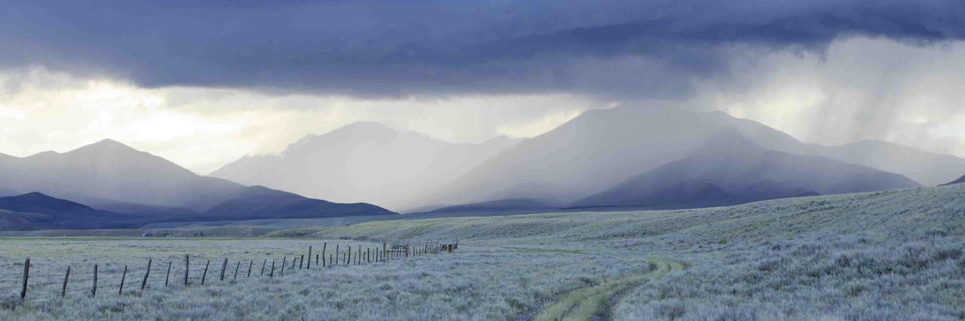 Rain showers over sagebrush-steppe at the foot of the Sawtooth Mountains in Clark County, Idaho.